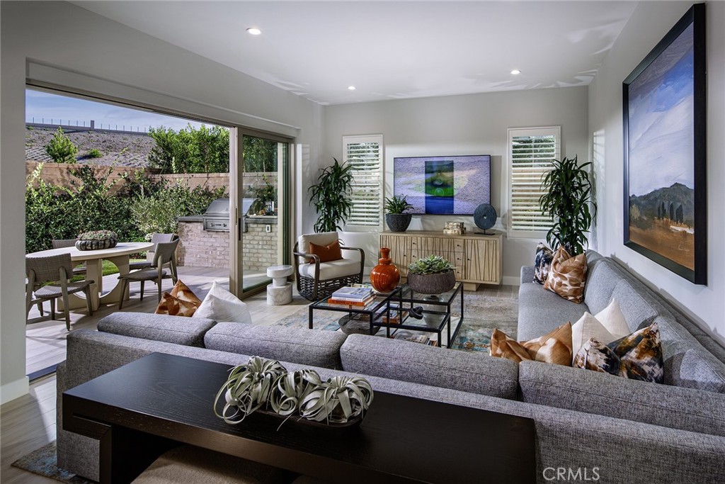214 Maricopa Irvine, CA 92618 - Photo 2 of 9 a living room with furniture and a flat screen tv