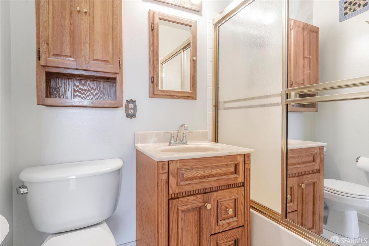 20 Inca Lane, Unit 2 San Francisco, CA 94115 - Photo 30 of 36 a bathroom with a toilet sink and mirror