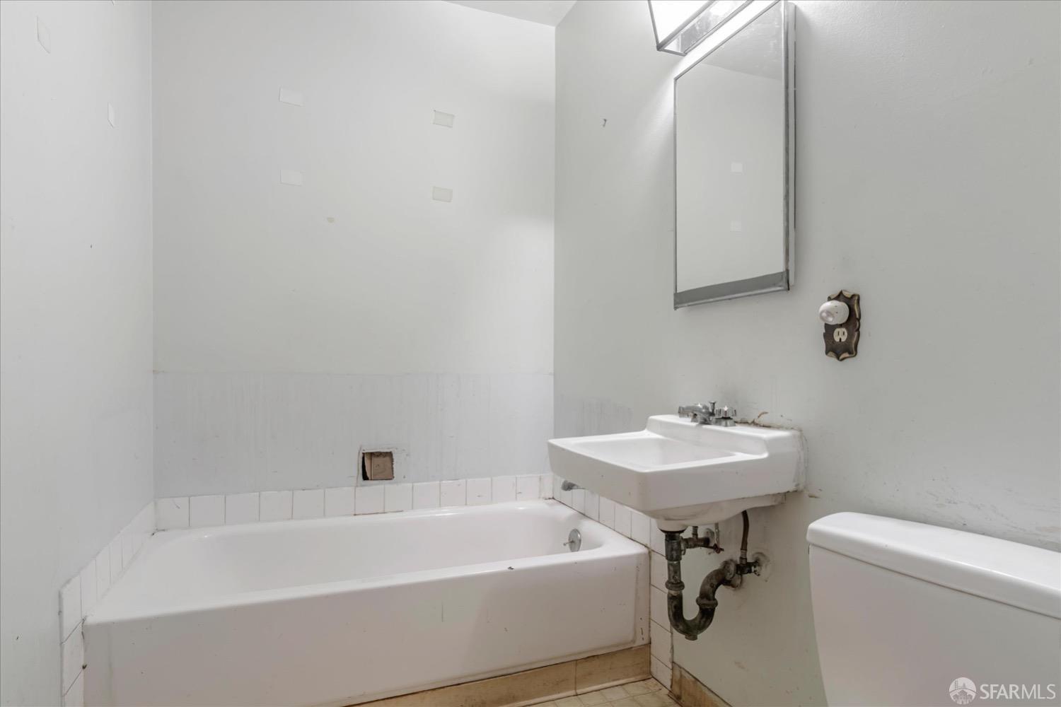 20 Inca Lane, Unit 2 San Francisco, CA 94115 - Photo 31 of 36 a white bath tub sitting next to a white sink and a mirror
