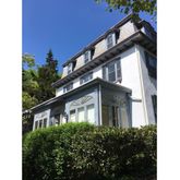 a yellow building with trees in front of it