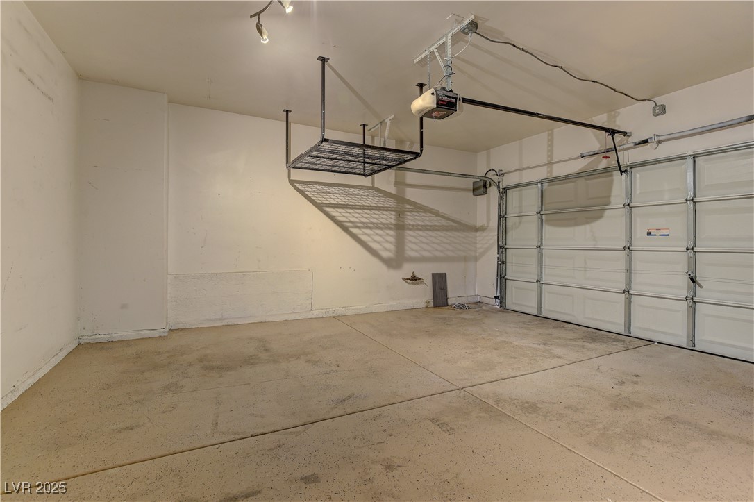 10654 Solar Hawk Avenue Las Vegas, NV 89129 - Photo 16 of 26 Garage with a garage door opener