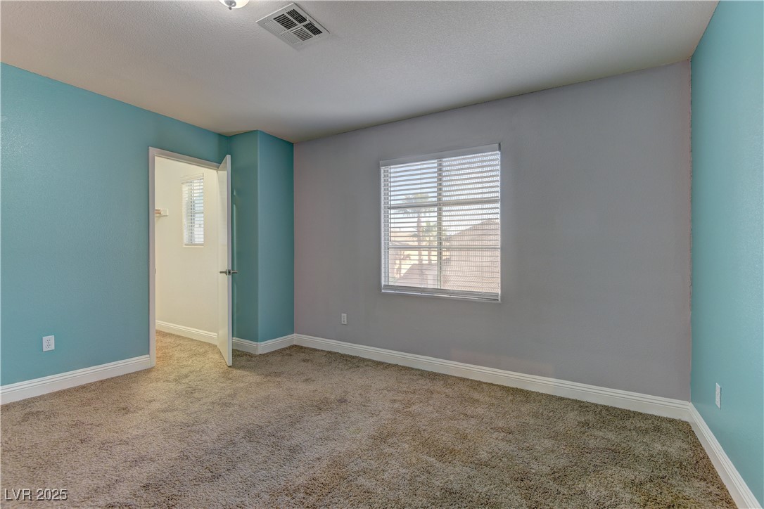 10654 Solar Hawk Avenue Las Vegas, NV 89129 - Photo 21 of 26 Empty room featuring carpet flooring and baseboards