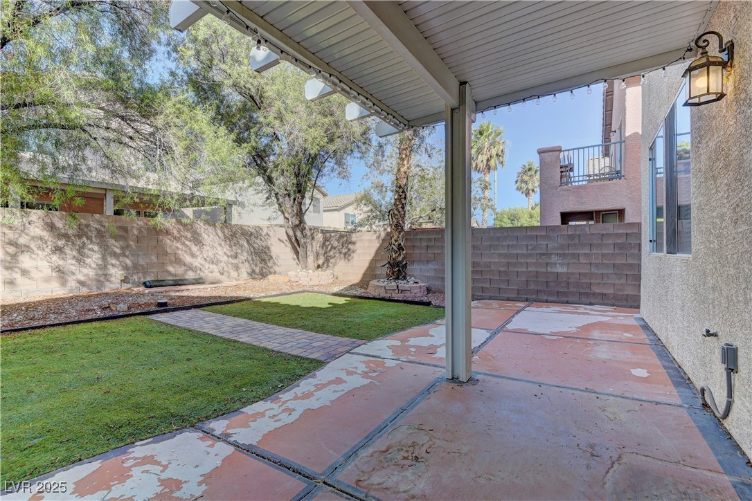 10654 Solar Hawk Avenue Las Vegas, NV 89129 - Photo 24 of 26 Fenced backyard with a patio area