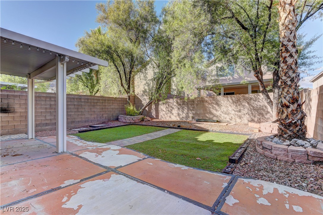 10654 Solar Hawk Avenue Las Vegas, NV 89129 - Photo 26 of 26 Fenced backyard with a patio