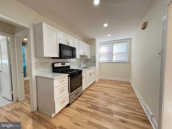 a kitchen with granite countertop a refrigerator and a stove