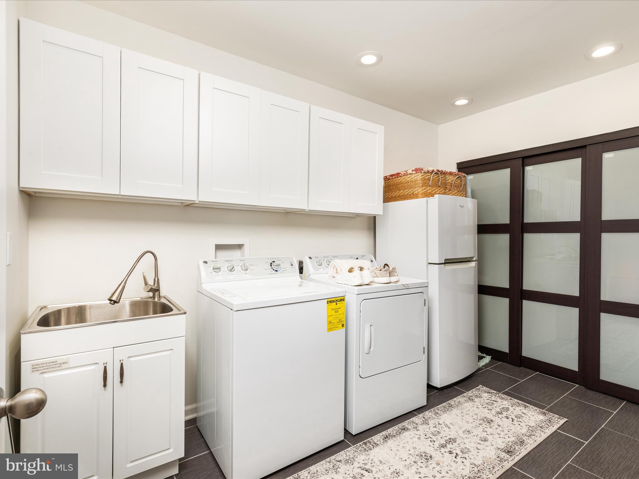 1303 Wedgewood Manor Way Reston, VA 20194 - Photo 49 of 57 Expansive laundry room with sliding doors + cabs