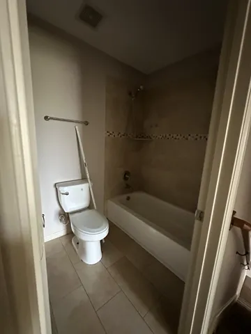 a bathroom with a toilet and a bathtub