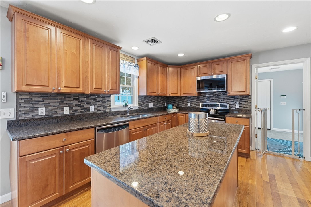 264 Round Top Road Burrillville, RI 02830 - Photo 12 of 49 New stainless steel appliances, tile backsplash, granite counter tops
