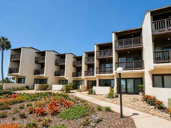a front view of a building with a garden