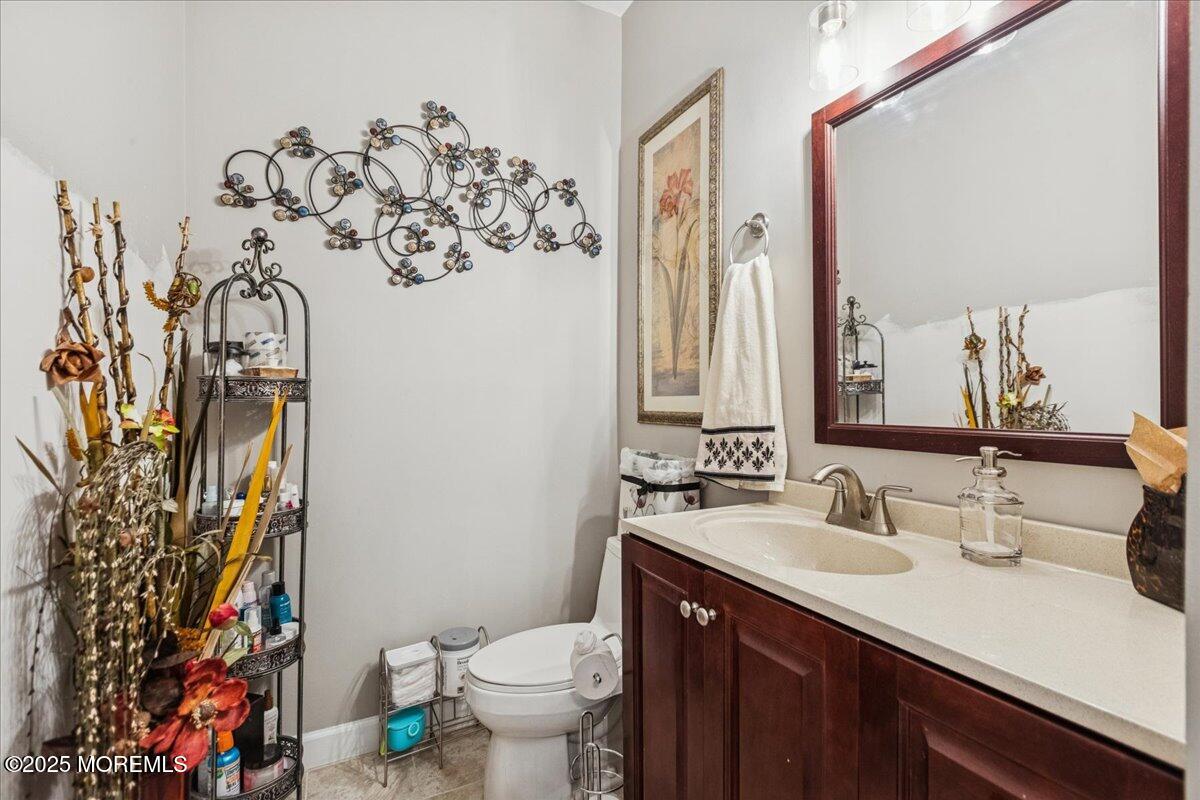16 Longbrook Lane, Unit 16 Freehold, NJ 07728 - Photo 15 of 28 a bathroom with a sink vanity mirror and toilet