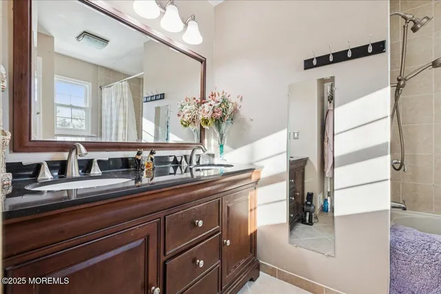 a en suite bathroom with a sink double vanity and a mirror