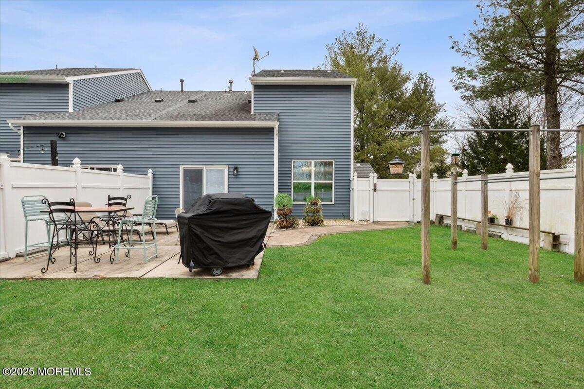 16 Longbrook Lane, Unit 16 Freehold, NJ 07728 - Photo 25 of 28 a view of a chair and table in backyard of the house