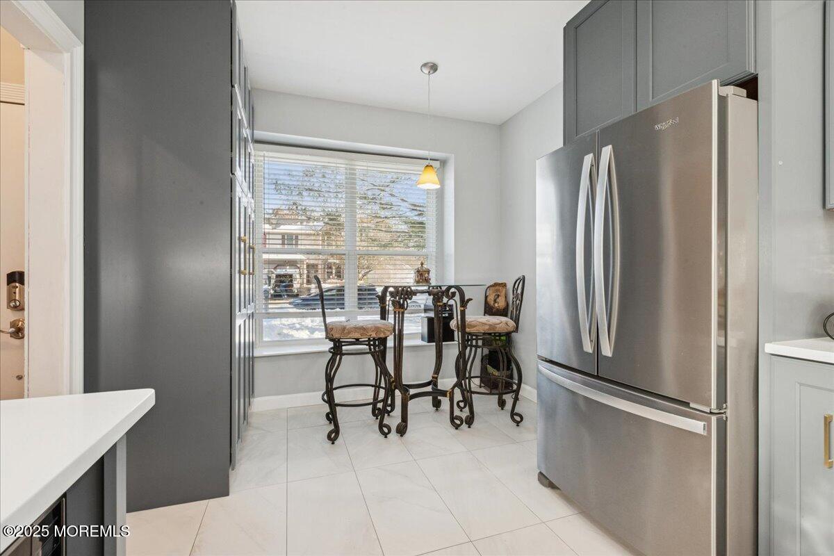 16 Longbrook Lane, Unit 16 Freehold, NJ 07728 - Photo 5 of 28 a kitchen with stainless steel appliances a refrigerator a table and chairs