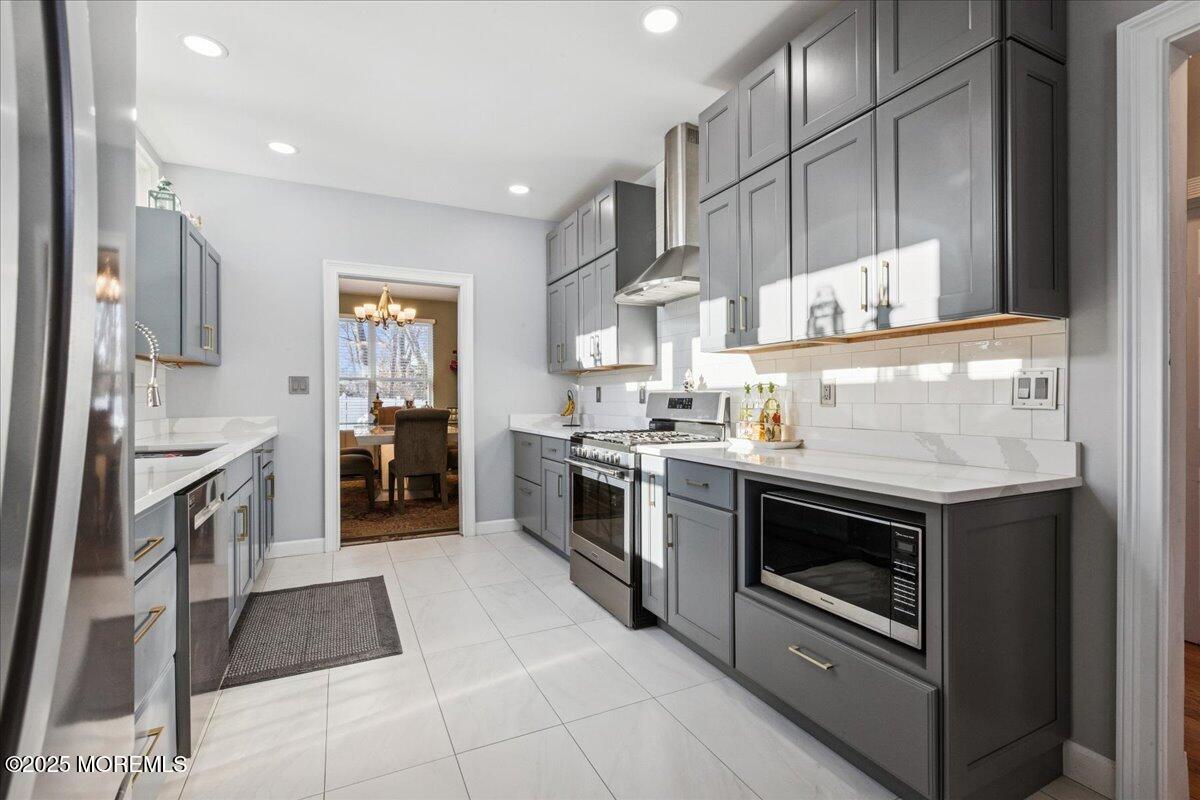 16 Longbrook Lane, Unit 16 Freehold, NJ 07728 - Photo 6 of 28 a kitchen with stainless steel appliances granite countertop a stove a sink and a refrigerator