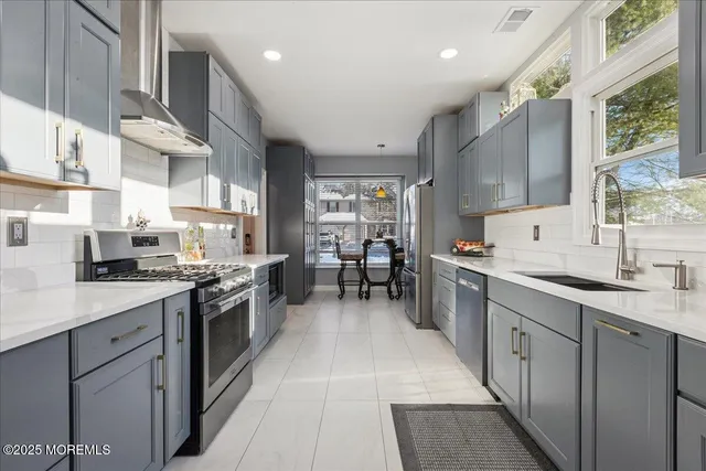 a kitchen with stainless steel appliances granite countertop lots of counter top space a sink and cabinets