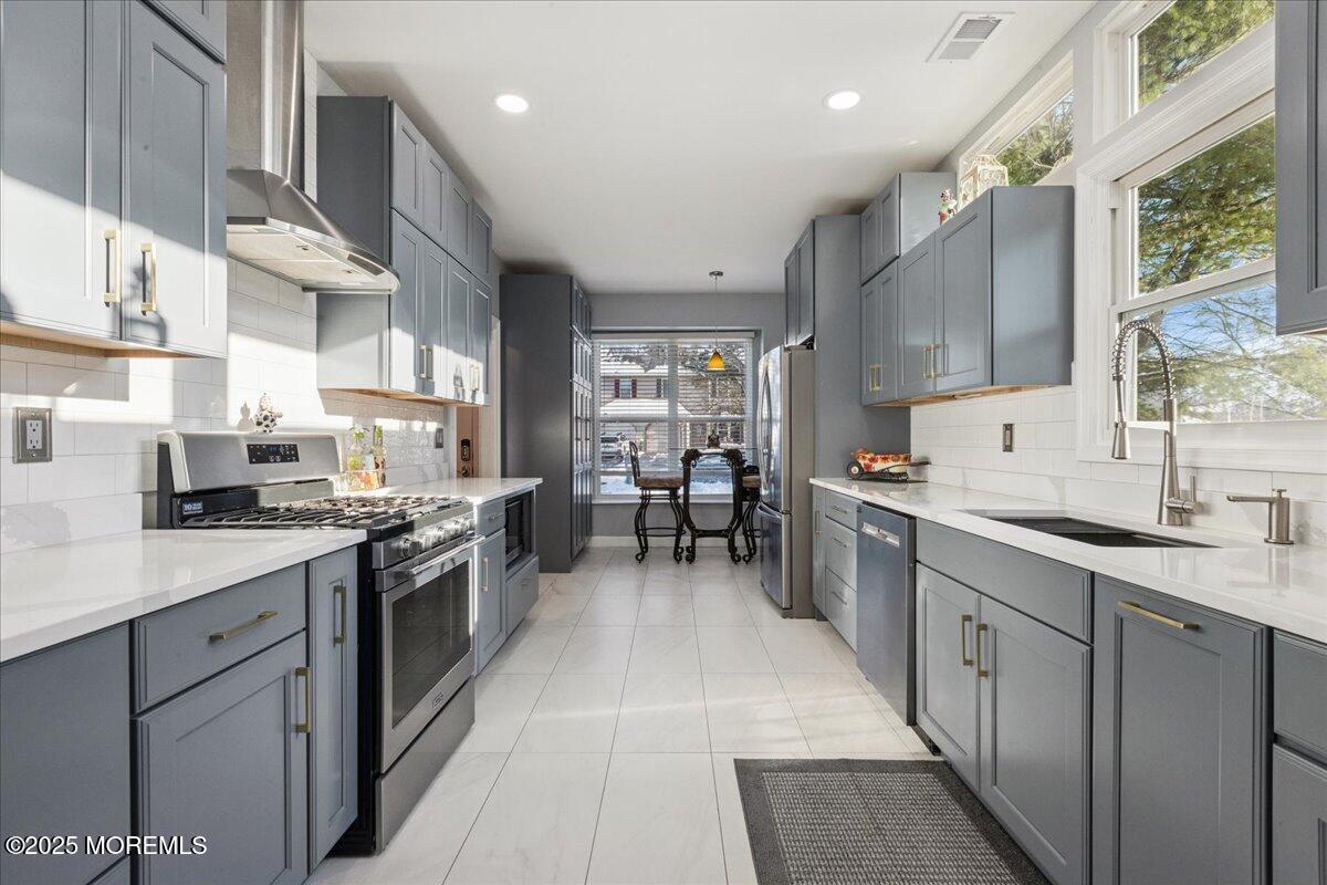 16 Longbrook Lane, Unit 16 Freehold, NJ 07728 - Photo 9 of 28 a kitchen with stainless steel appliances granite countertop lots of counter top space a sink and cabinets