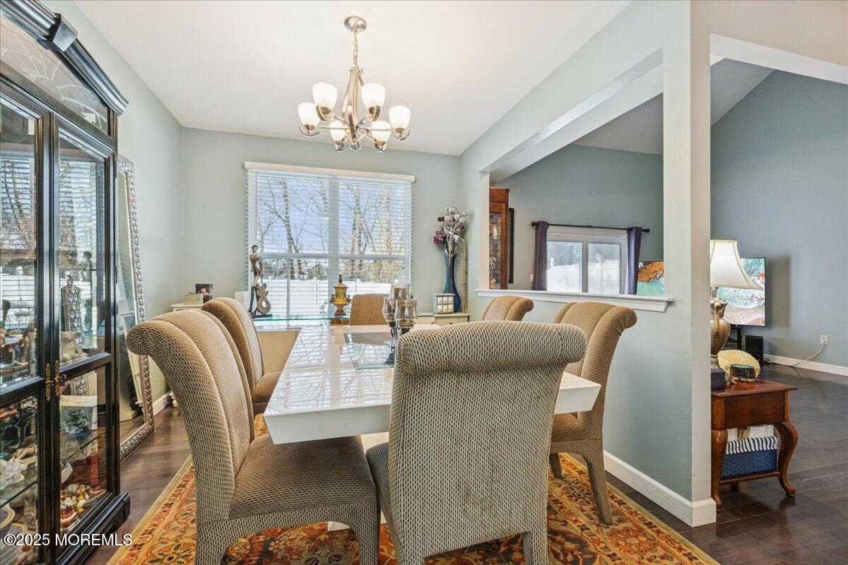 16 Longbrook Lane, Unit 16 Freehold, NJ 07728 - Photo 10 of 28 a living room with furniture and a chandelier