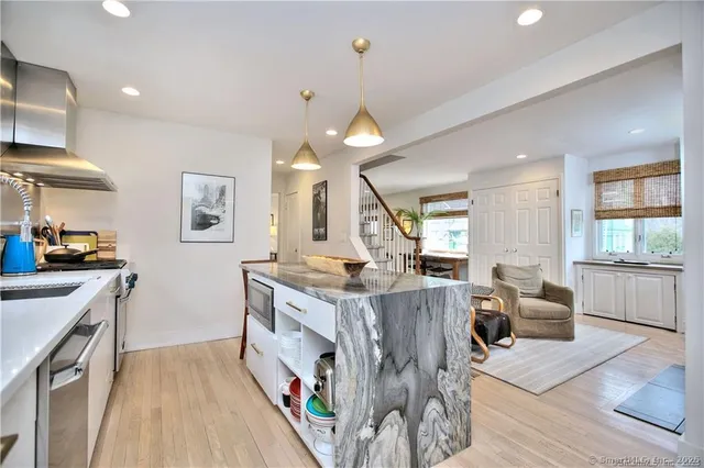 a kitchen with stainless steel appliances granite countertop a stove and cabinets
