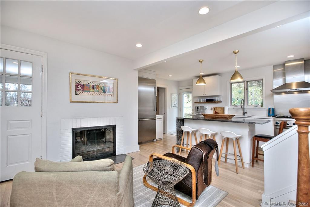 28 Narrow Rocks Road Westport, CT 06880 - Photo 13 of 35 a living room with furniture a kitchen and a fireplace
