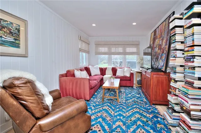 a living room with furniture and a book shelf