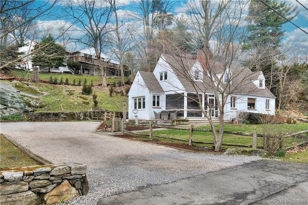 28 Narrow Rocks Road Westport, CT 06880 - Photo 2 of 35 front view of a house with a yard and an trees