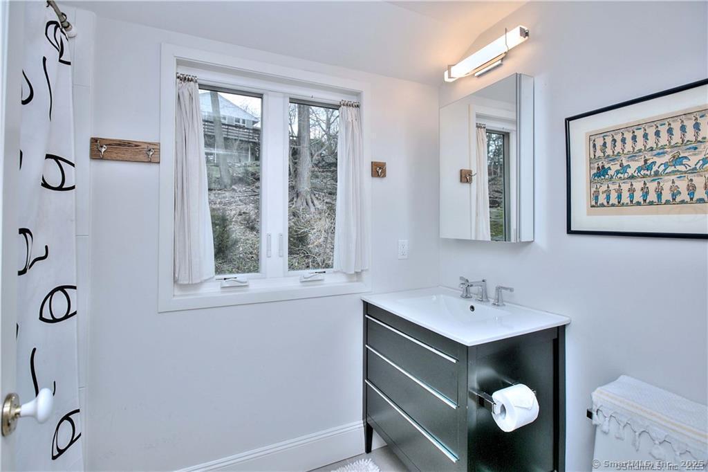 28 Narrow Rocks Road Westport, CT 06880 - Photo 27 of 35 a bathroom with a sink and mirror with window