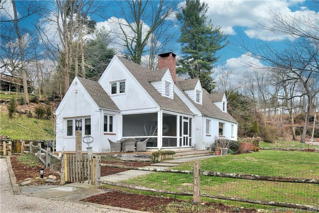 28 Narrow Rocks Road Westport, CT 06880 - Photo 30 of 35 a front view of a house with a yard and potted plants