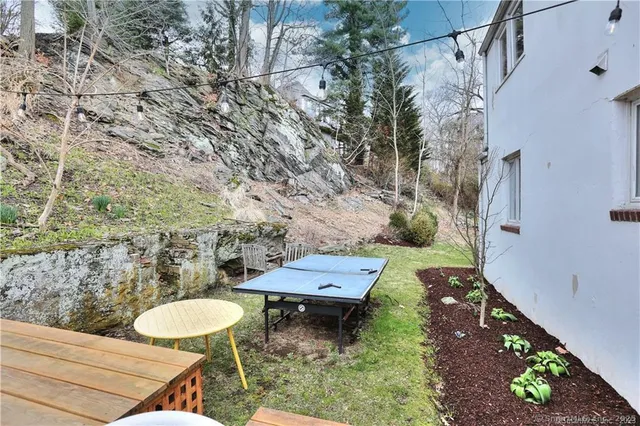a view of a backyard with chairs and a table