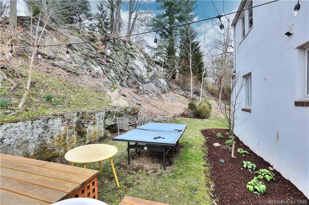 28 Narrow Rocks Road Westport, CT 06880 - Photo 34 of 35 a view of a backyard with chairs and a table