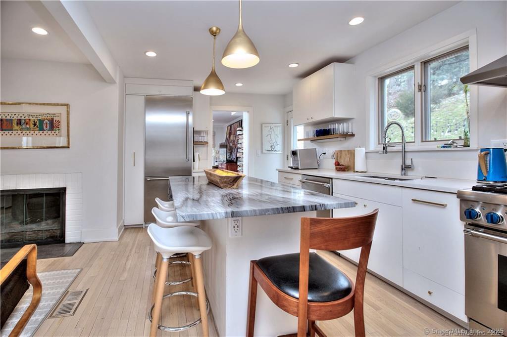 28 Narrow Rocks Road Westport, CT 06880 - Photo 10 of 35 a kitchen with kitchen island a dining table chairs cabinets and stainless steel appliances