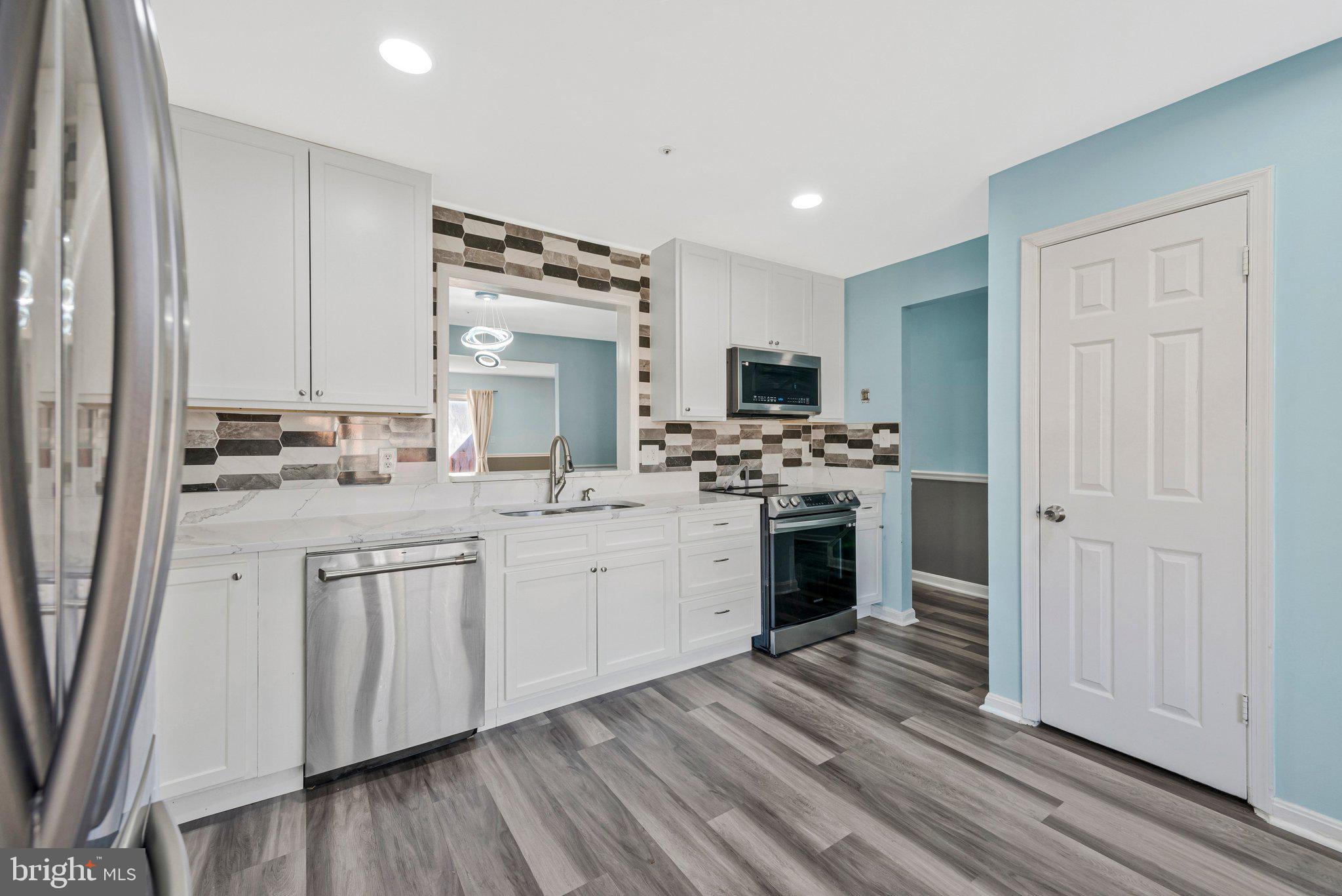 4675 Red Hawk Terrace Bladensburg, MD 20710 - Photo 3 of 14 a kitchen with sink cabinets and wooden floor