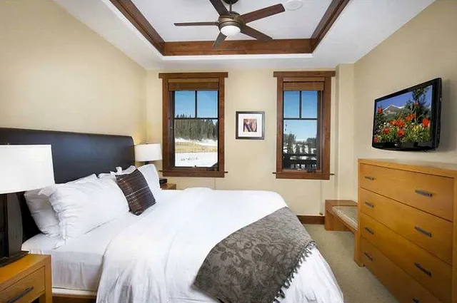 a bedroom with a bed and a flat screen tv