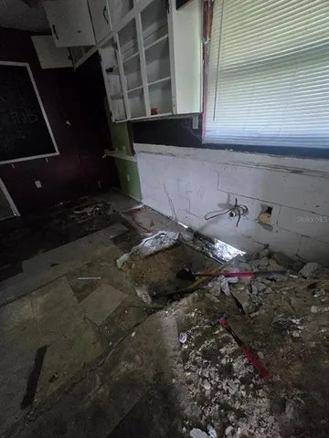 a kitchen with stainless steel appliances kitchen island granite countertop a stove a sink and a microwave