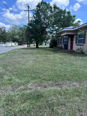 a view of a backyard with large trees