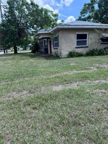 a view of a backyard with large trees