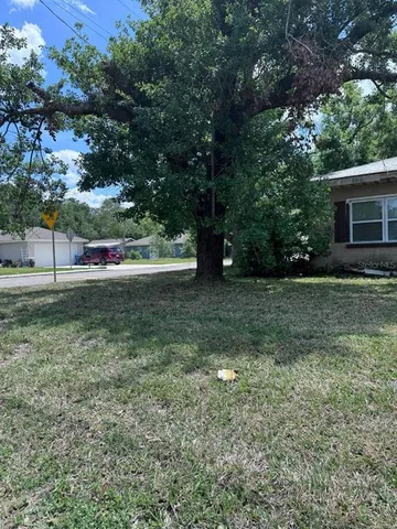 a view of house with outdoor space and garden