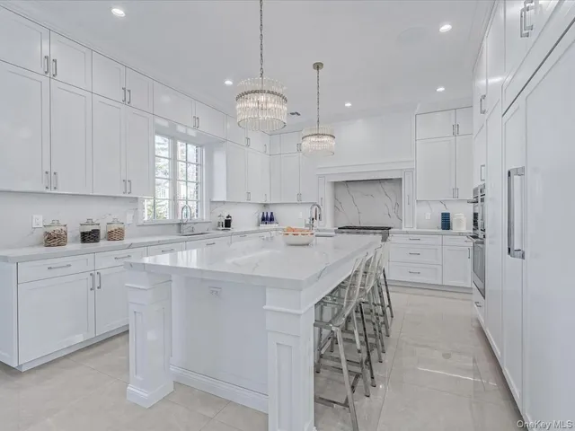 a kitchen with kitchen island granite countertop a sink a center island and cabinets