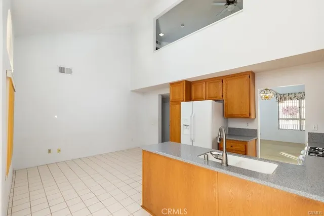 a spacious bedroom with a large bed and a chandelier