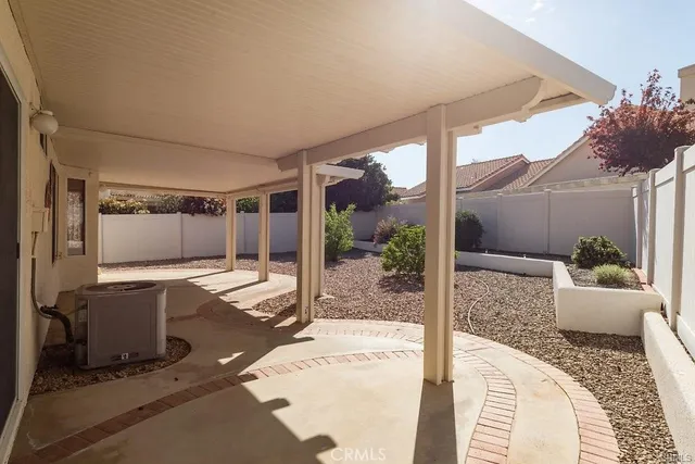 a view of a patio with table and chairs potted plants