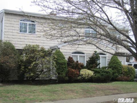 50 Riverside Avenue Merrick, NY 11566 - Photo 1 of 1 a front view of a house with lots of trees