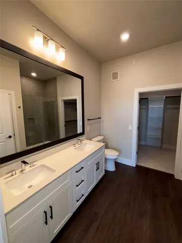 a bathroom with a double vanity sink and a mirror