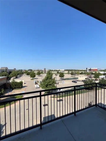 a view of a balcony with wooden floor and city view