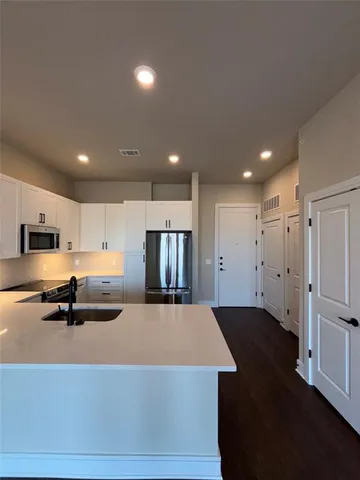 a kitchen with kitchen island a stove and a refrigerator
