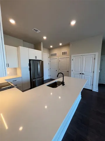 a kitchen with stainless steel appliances a refrigerator and a sink