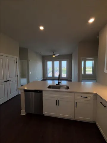a kitchen with stainless steel appliances a sink and cabinets