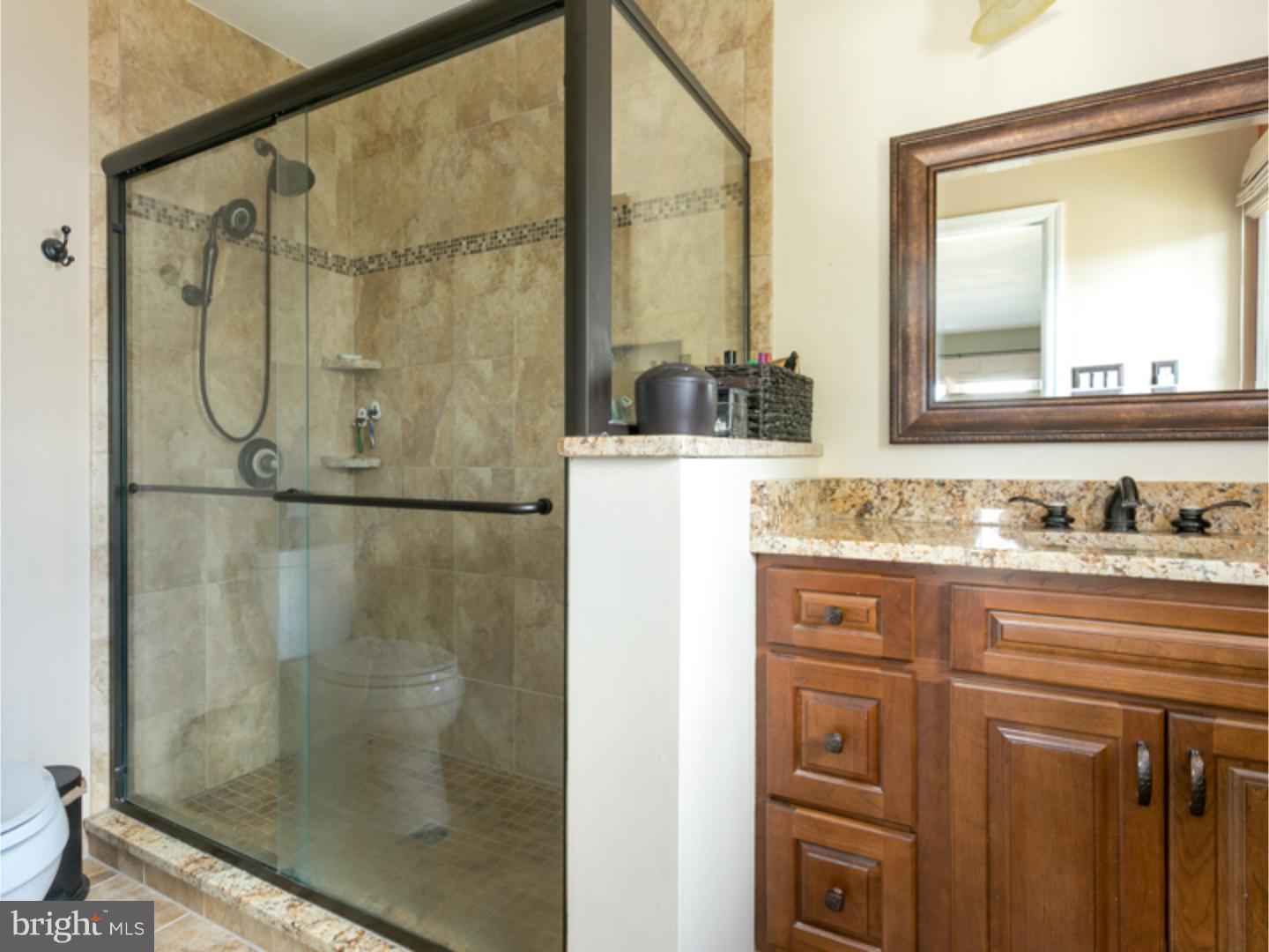7 Baggaley Road Hamilton Square, NJ 08690 - Photo 17 of 24 a bathroom with a granite countertop sink a mirror and a shower
