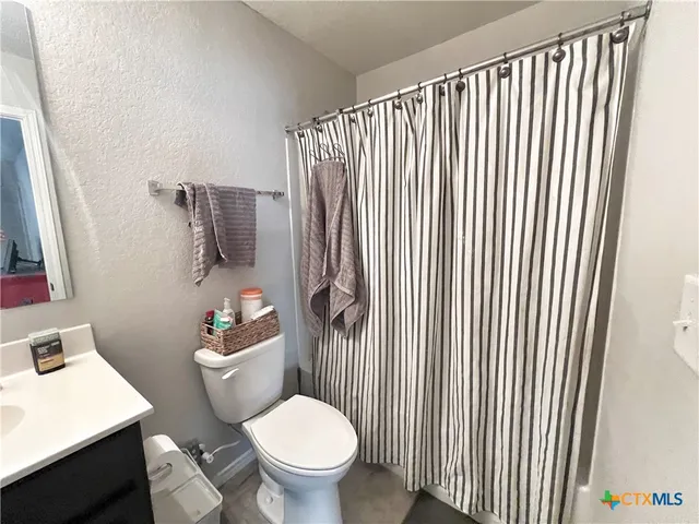 a white toilet sitting next to a bathroom sink