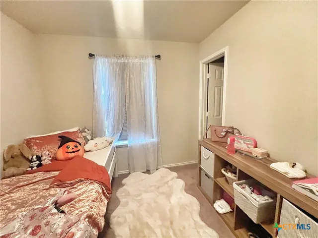 a bedroom with a bed and a dresser in it