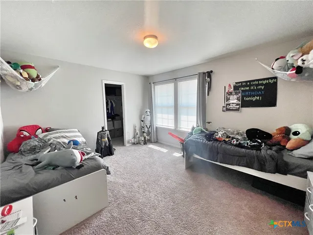 a bedroom with furniture and a window