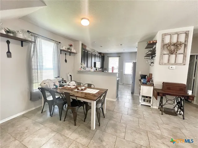 a view of a dining room with furniture and a window